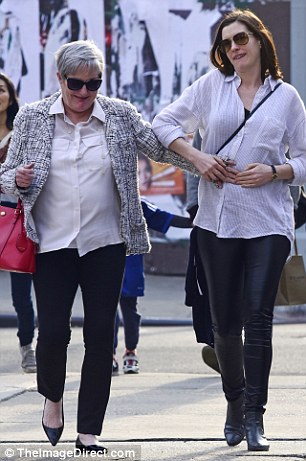 Bonding moment: During their stroll in downtown, the movie star placed her mom's hand on the center of her baby bump