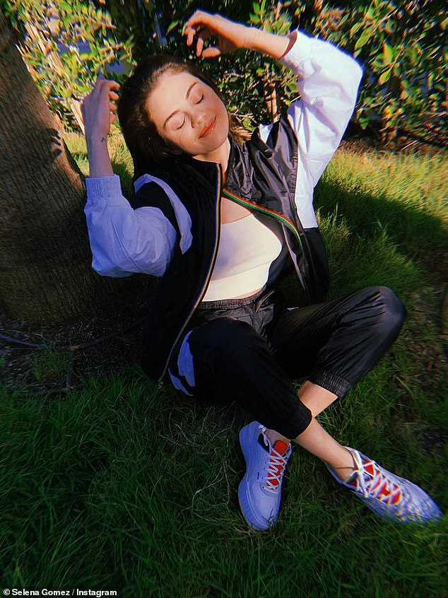 Brand ambassador: Selena Gomez took to Instagram on Sunday to share at-home photos of herself wearing Puma sneakers in her yard