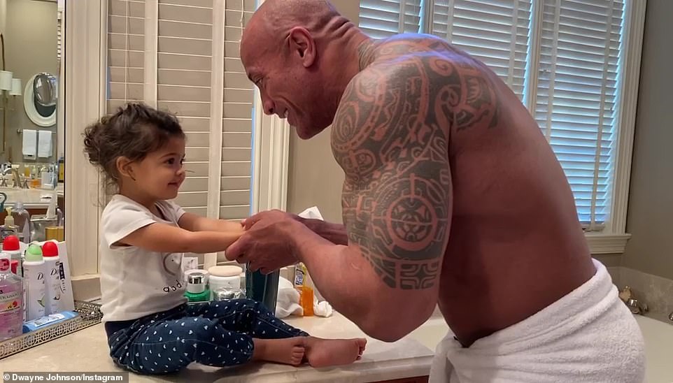 Alongside a sweet snap of his daughter posted on Instagram, Dwayne Johnson wrote: 'Our sheltering at home, pre daddy's shower ritual Before my showers now, Baby Tia (mama mia) demands I sing the rap portion of my song "You're Welcome" from MOANA, while I wash her hands. We realised a few weeks ago that the rap portion of the song is perfect timing when getting your little ones to have fun washing their hands. Stay healthy and safe, my friends'