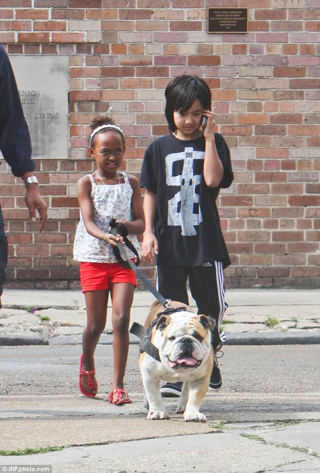 Say woof! The Jolie-Pitt clan with another of their pets in 2012