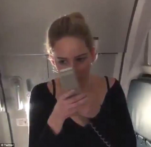 Say it loud and proud: The 27-year-old actress picked up the phone-like microphone and said: 'Everybody, this is not the pilot speaking. This is Jennifer Lawrence.'