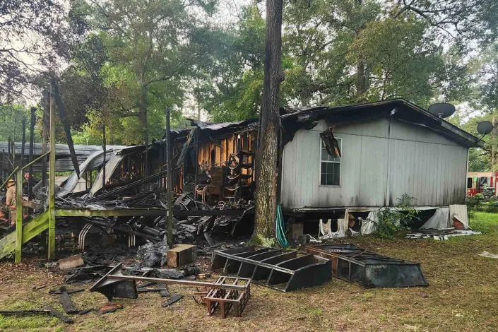 Magnolia Fire Department/Facebook Scene of Magnolia house fire that killed two